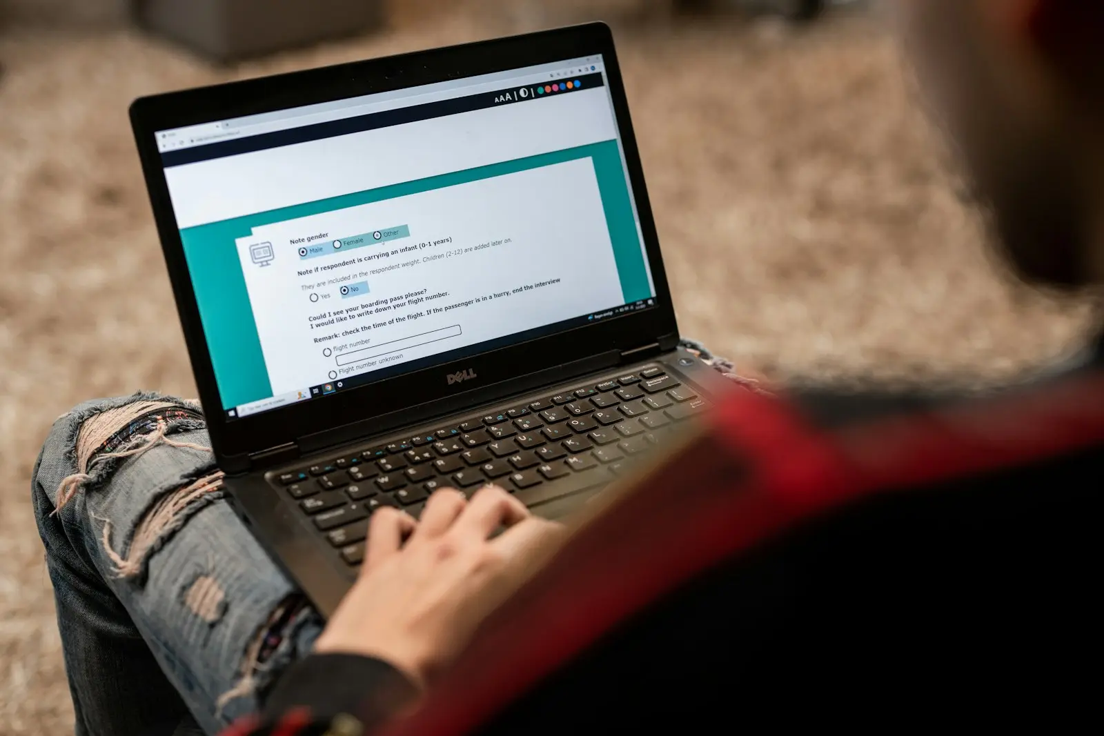 A person completing an online questionnaire on a laptop